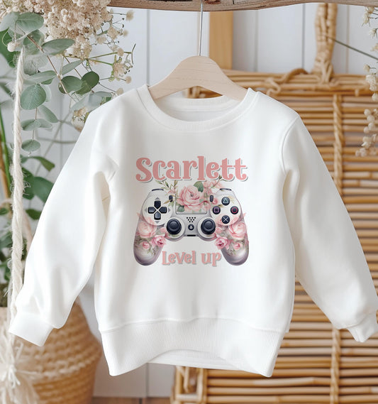 Personalised white cotton sweatshirt with flower and gaming controller design and custom name, baby size 6-12 months