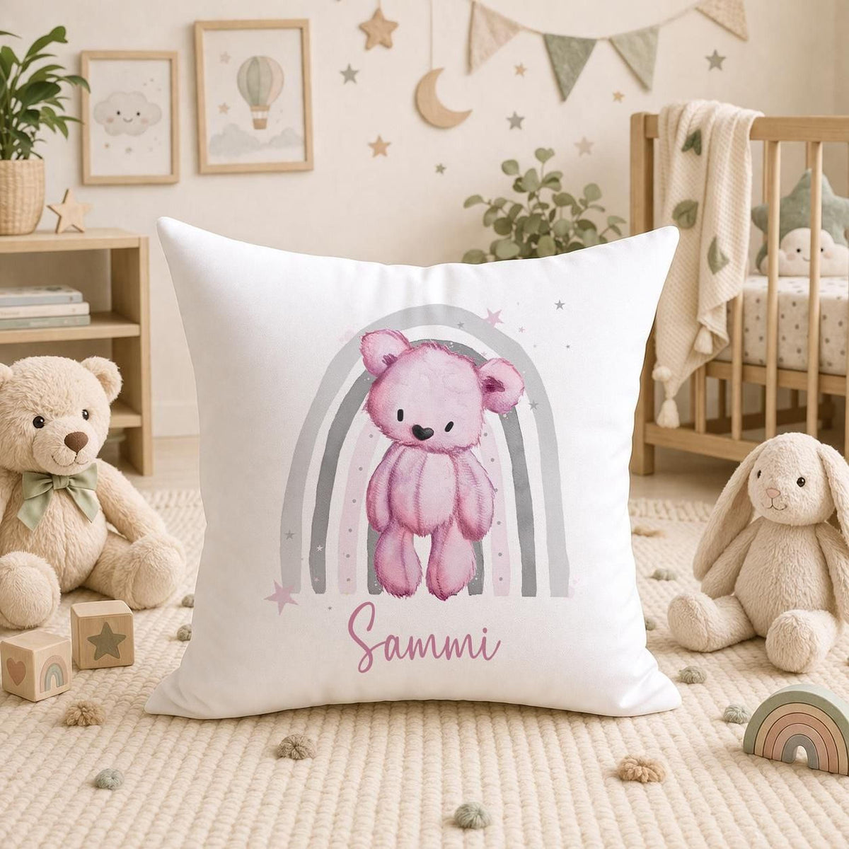 Personalised teddy bear cushion with a pink rainbow nursery design, front view