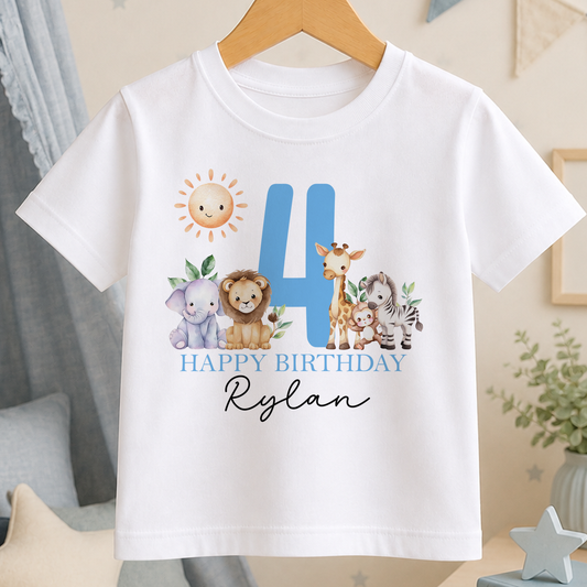 A white t-shirt with a graphic design featuring a blue number 4, surrounded by various animal illustrations, including a lion, giraffe, and elephant. The text "HAPPY BIRTHDAY Rylan" is displayed below the number.