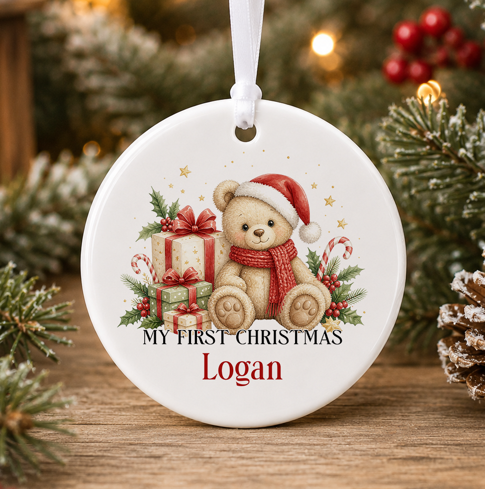 Personalised teddy bear My First Christmas bauble, white ceramic ornament with a teddy bear in a Santa hat and red scarf, presents with red bows and candy canes, printed with a baby's name in red