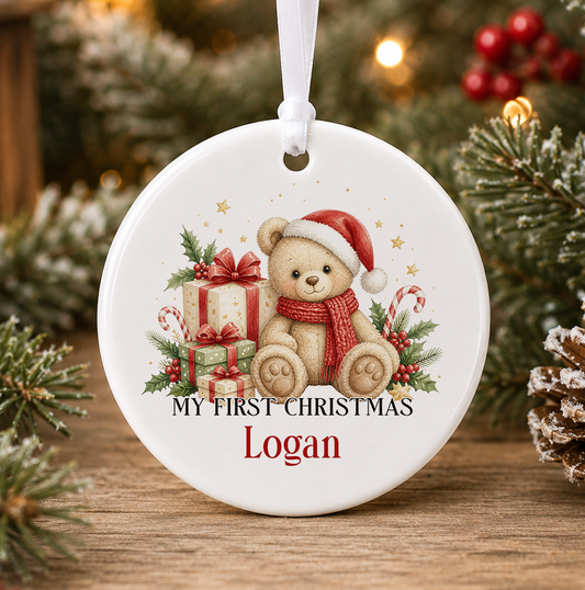 Personalised teddy bear My First Christmas bauble, white ceramic ornament with a teddy bear in a Santa hat and red scarf, presents with red bows and candy canes, printed with a baby's name in red