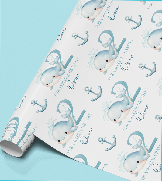 Flat lay of the personalised whale birthday wrapping paper showing the repeat whale and anchor pattern