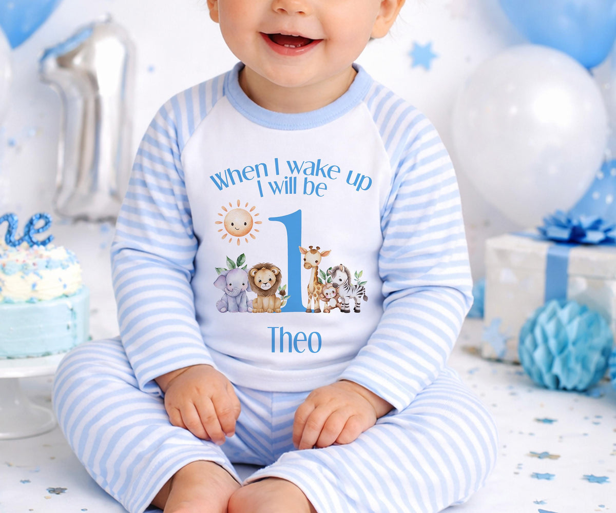 Personalised blue striped safari pyjamas for a 1st birthday with custom name printed on the front