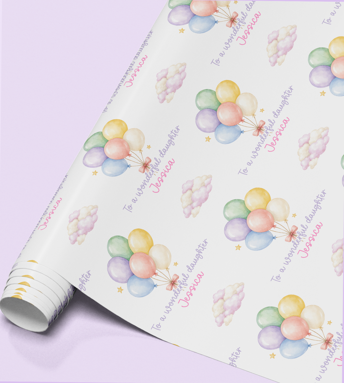 Close-up of the pastel balloon wrapping paper pattern showing the personalised name in print