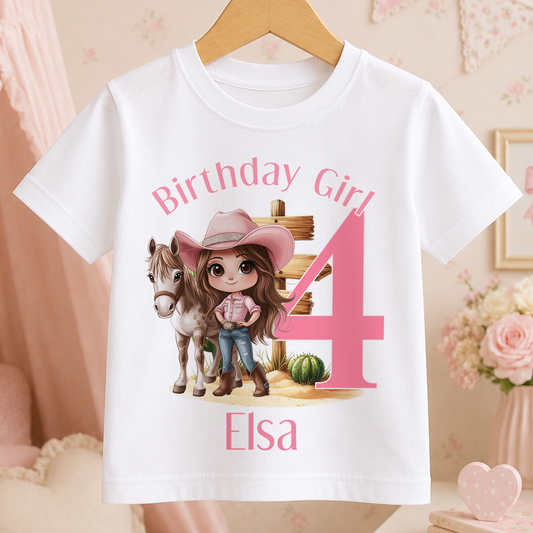 A white t-shirt with a cartoon image of a girl wearing a cowboy hat and standing next to a horse, along with the text "Birthday Girl 4" and "Elisa".