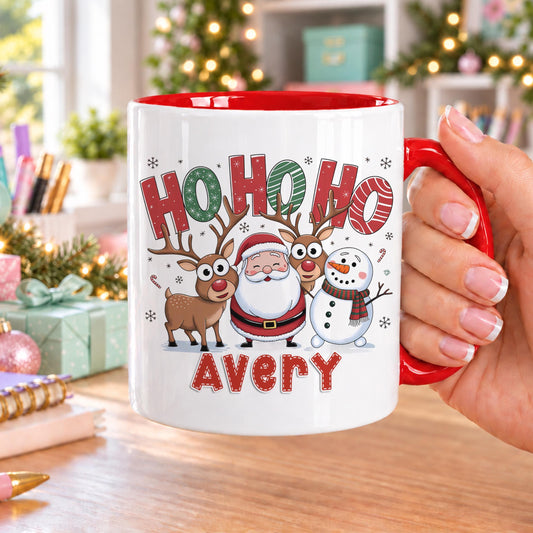 Personalised Christmas mug with red handle and inside, printed with HO HO HO above Santa, a reindeer and a snowman, and a name in red below