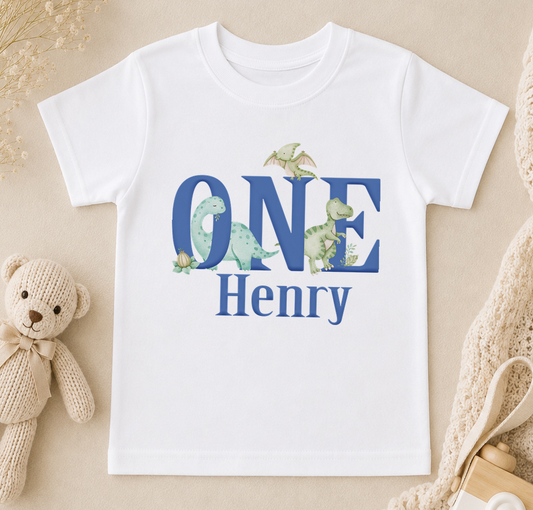 A white t-shirt with the text "ONE Henry" printed on it, surrounded by illustrations of various dinosaurs.