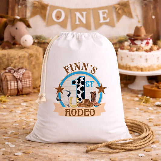 White A3 drawstring party bag printed with a cowboy-themed First Rodeo design and personalised child's name.