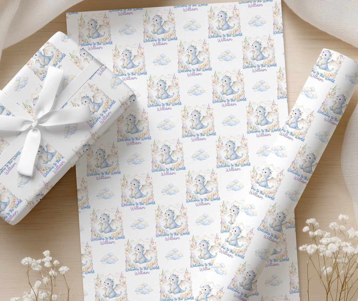 Close-up of the blue dragon and pastel castle pattern on the personalised baby wrapping paper
