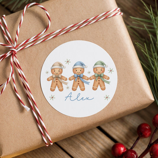 Personalised gingerbread trio Christmas sticker with custom name on a wrapped gift box with striped ribbon