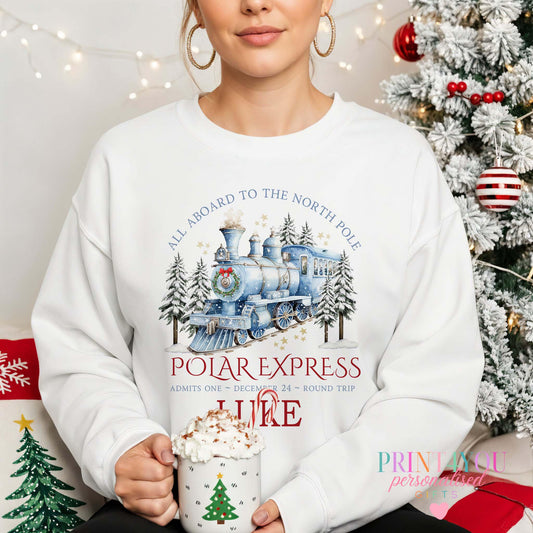 Unisex Christmas jumper with blue Polar Express steam train, snowy pines and stars design, size X Small