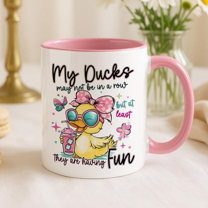 White ceramic mug printed with a row of cartoon ducks and a fun quote