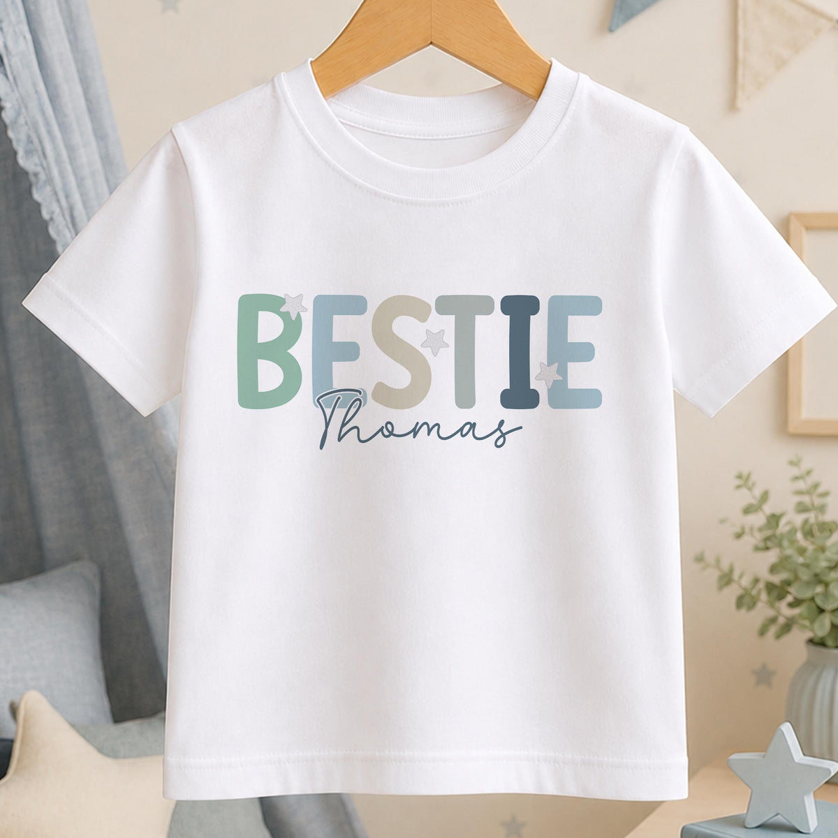 Personalised Bestie t-shirt – white tee with BESTIE in sage and dusky pink lettering and the name Thomas in script