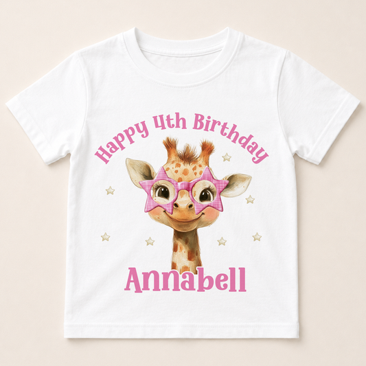 White cotton birthday t-shirt printed with a cartoon giraffe wearing pink star-shaped glasses, personalised with a custom name and age birthday message