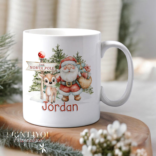 White ceramic Christmas mug personalised with a name, printed with a Santa and reindeer design in bright festive colours