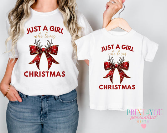 Mum and toddler wearing matching Christmas t-shirts printed with a red bow and antlers design and 'Just a girl who loves Christmas'