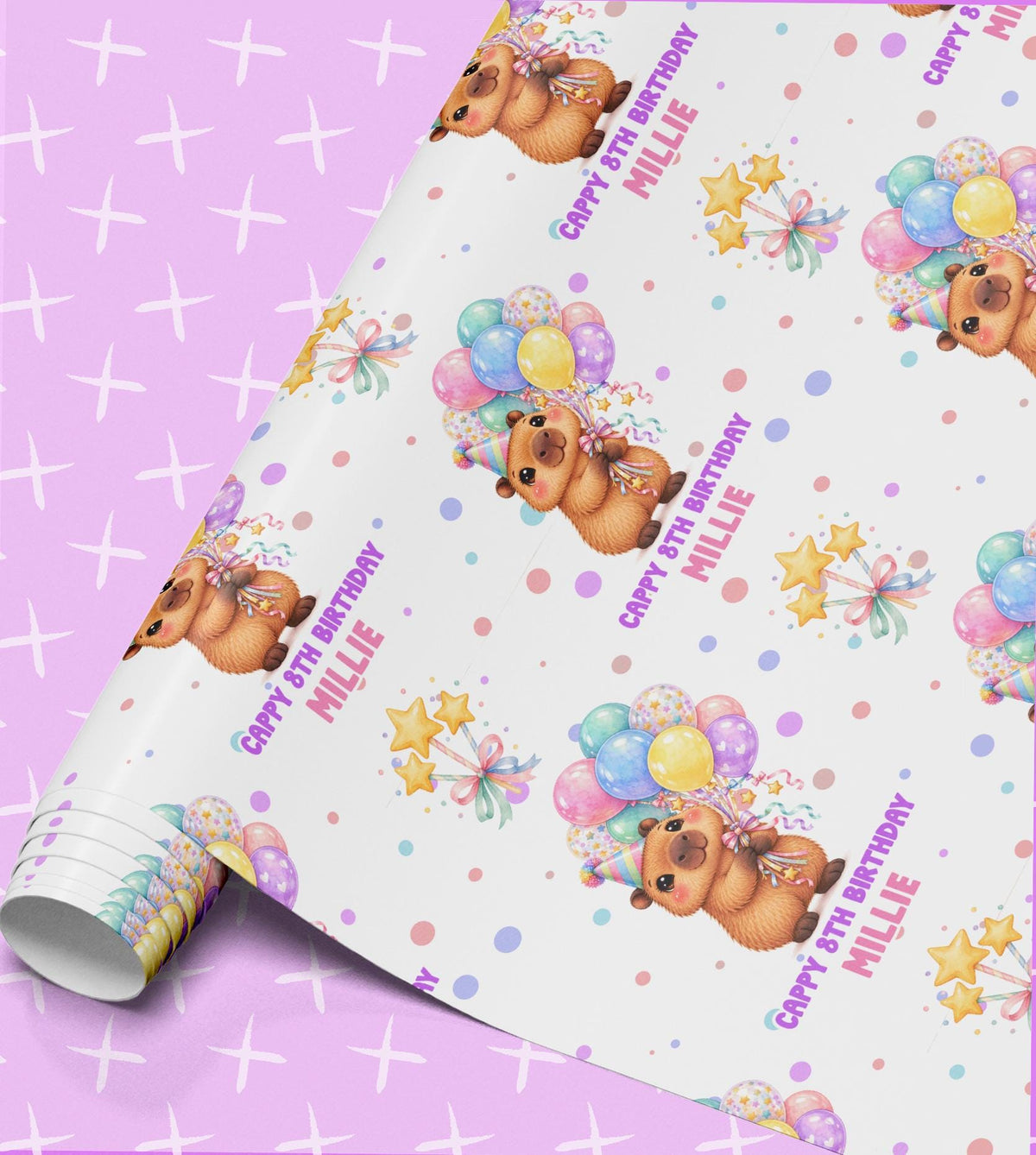 Birthday wrapping paper printed with capybaras in party hats holding pastel balloon bunches, ribbon tied stars and confetti dots, with Cappy 8th Birthday and the name Millie on a white background, shown part unrolled