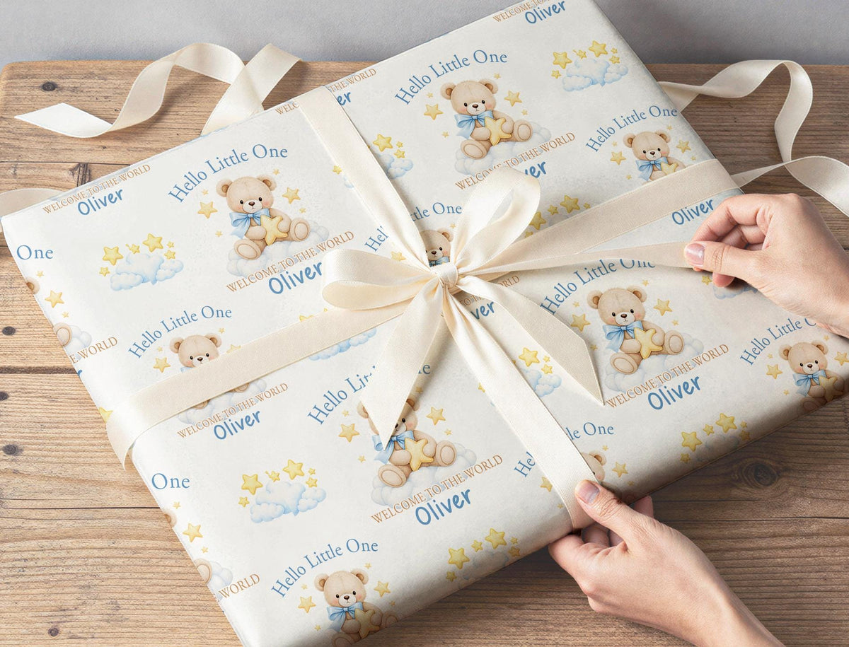 New baby gift wrapped in personalised Hello Little One teddy bear wrapping paper with custom name