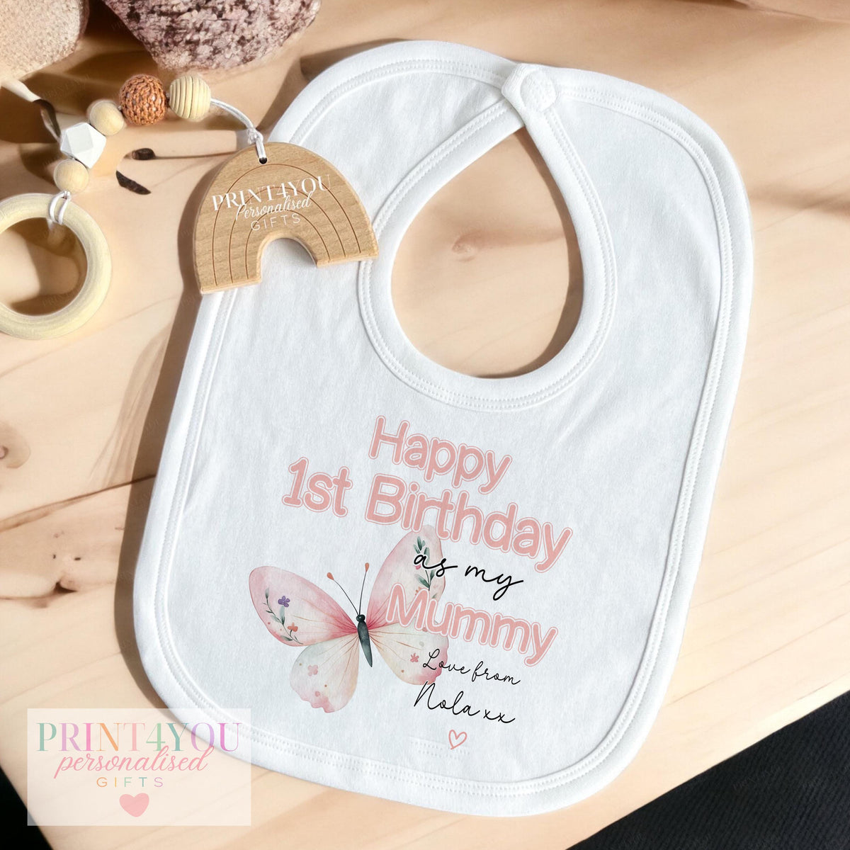 Personalised butterfly 1st birthday keepsake outfit laid flat, shown with a custom baby name added.