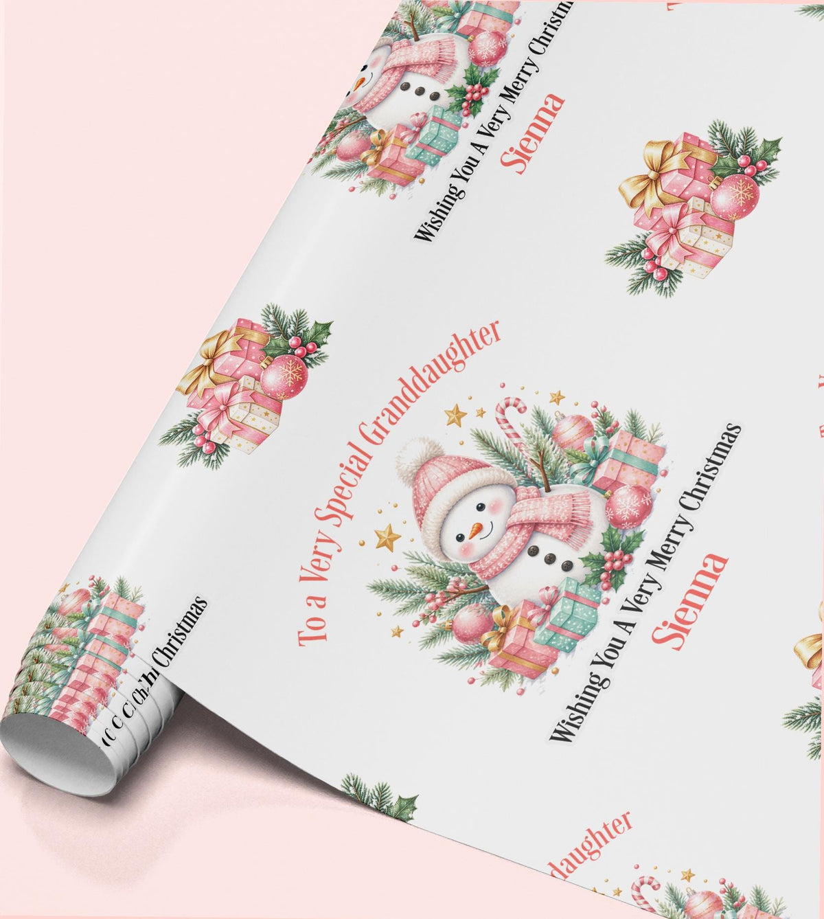 Rolled sheet of personalised pink snowman Christmas wrapping paper with a name and relation