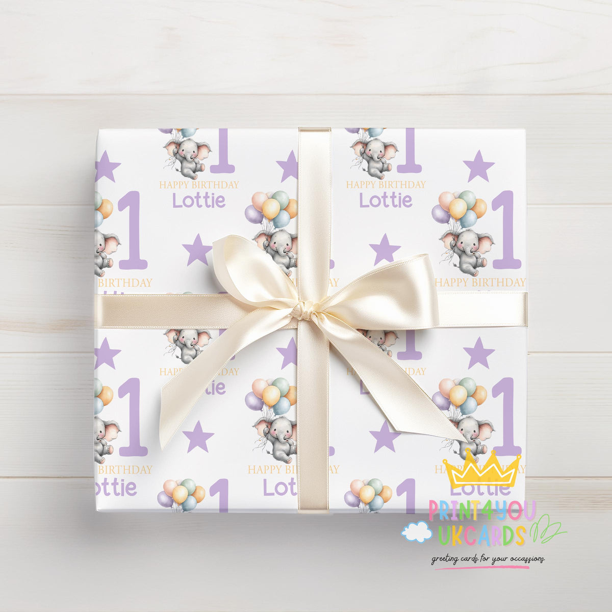 Personalised purple elephant 1st birthday wrapping paper wrapped around a gift