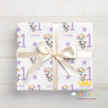 Personalised purple elephant 1st birthday wrapping paper wrapped around a gift