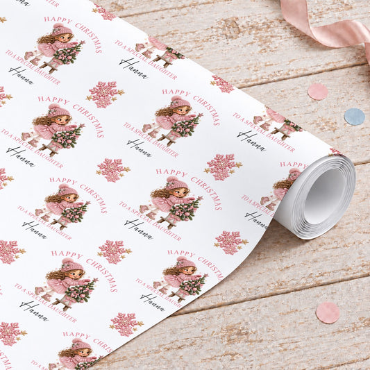 Personalised Christmas wrapping paper roll with a girl in a pink bobble hat decorating a Christmas tree, Happy Christmas, To a Special Daughter and the name Hanna