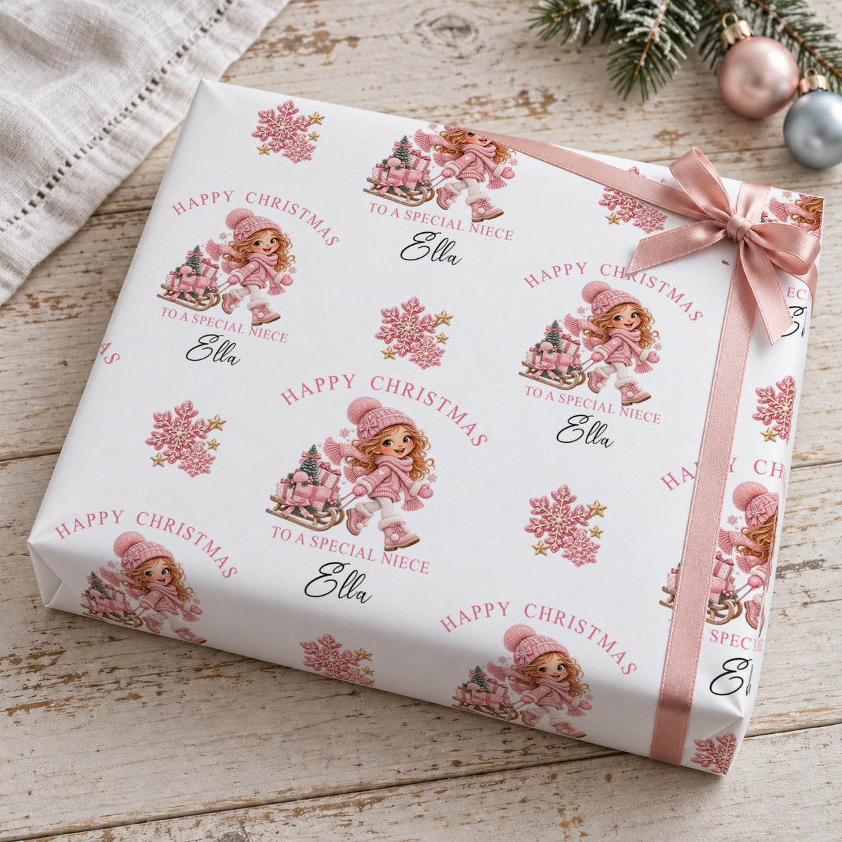 Present wrapped in personalised To A Special Niece Christmas wrapping paper with a pink bow