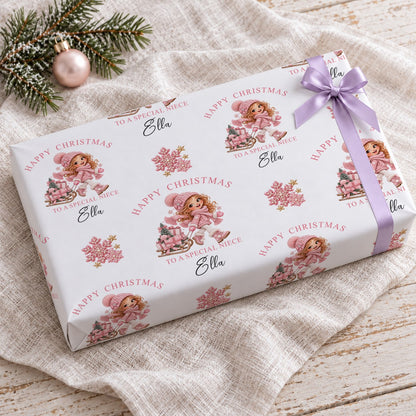Gift wrapped in personalised girl and sledge Christmas wrapping paper with a lilac bow on a linen cloth