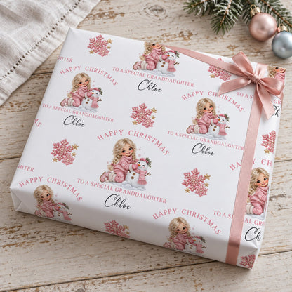 Present wrapped in personalised To A Special Granddaughter Christmas wrapping paper with a pink bow