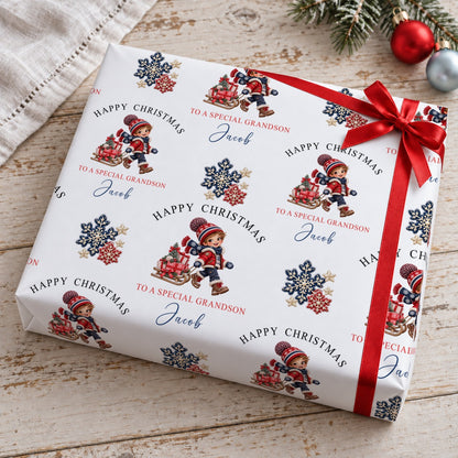 Gift wrapped in personalised grandson Christmas wrapping paper with navy and red snowflakes, tied with a red satin bow