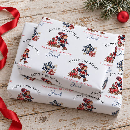 Two gifts stacked, wrapped in personalised boy and sledge Christmas wrapping paper printed with the name Jacob