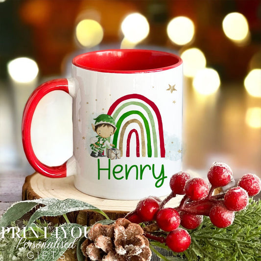 Personalised Elf Boy and Rainbow design Christmas mug in plain white ceramic, printed with a custom name on the front