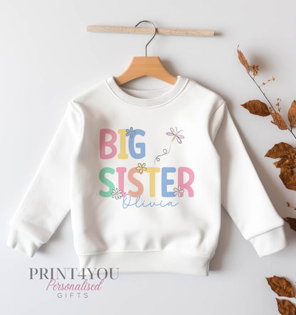 Pastel pink and lilac flower design personalised sister sweatshirt, shown in the 6-12 months size