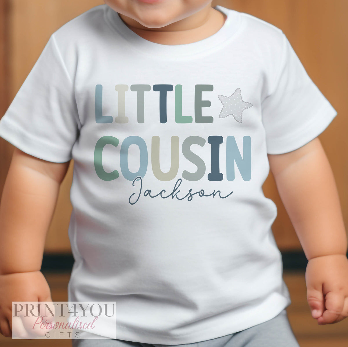Personalised Little Cousin sleepsuit with popper fastenings and printed name