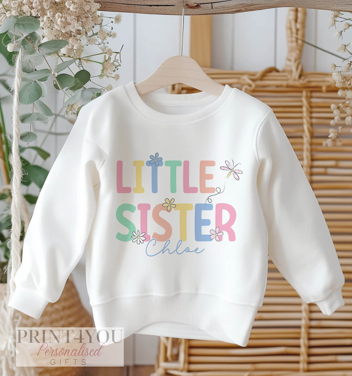Pastel pink and lilac flower design personalised sister sweatshirt, shown in the 1-2 years size