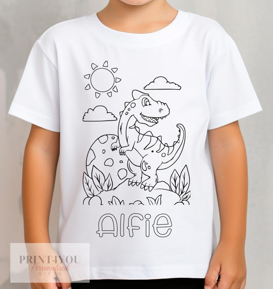 Child wearing a personalised colour-in dinosaur t-shirt with custom name printed on the front, ready to colour with washable pens, 1-2 years