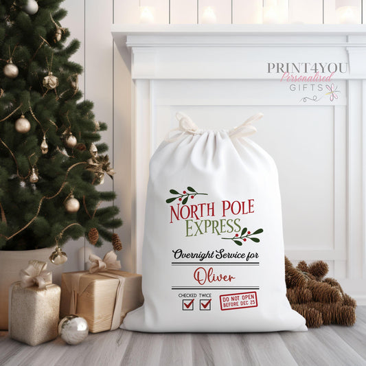 Large plain cream canvas Santa sack personalised with a name, shown with drawstring closure