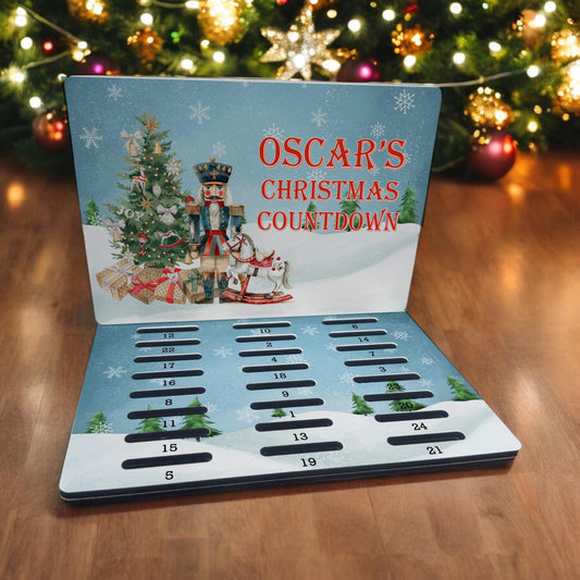 Personalised A5 MDF Christmas advent calendar with a toy soldier Nutcracker design and 24 numbered coin slots, personalised as Oscar's Christmas Countdown