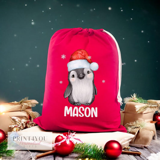 Personalised red Christmas sack with festive penguin design and custom name, front view