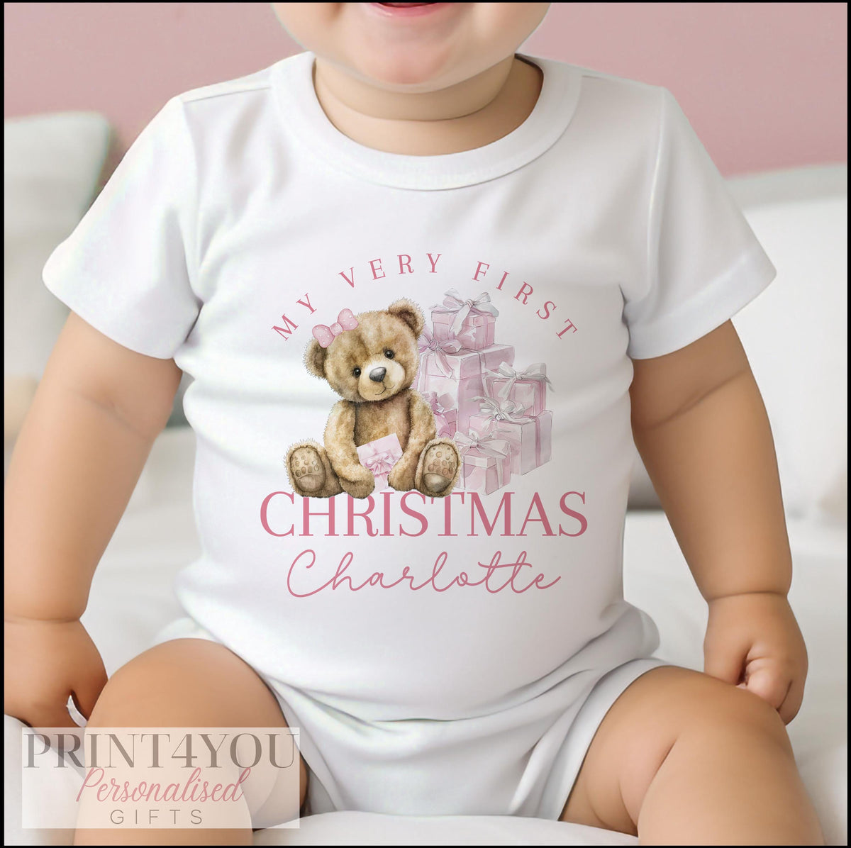 Newborn wearing personalised first Christmas sleepsuit
