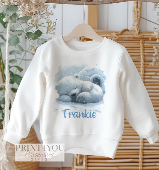 White cotton sweatshirt with a sleeping polar bear design beside an igloo, personalised with the name Frankie.