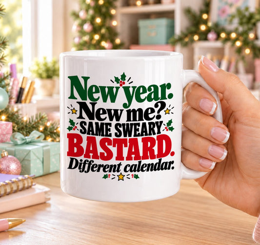 White 11oz ceramic Christmas mug printed with “New year. New me? Same sweary bastard. Different calendar.” in red, green and black lettering with holly and gold stars, held in a festive room