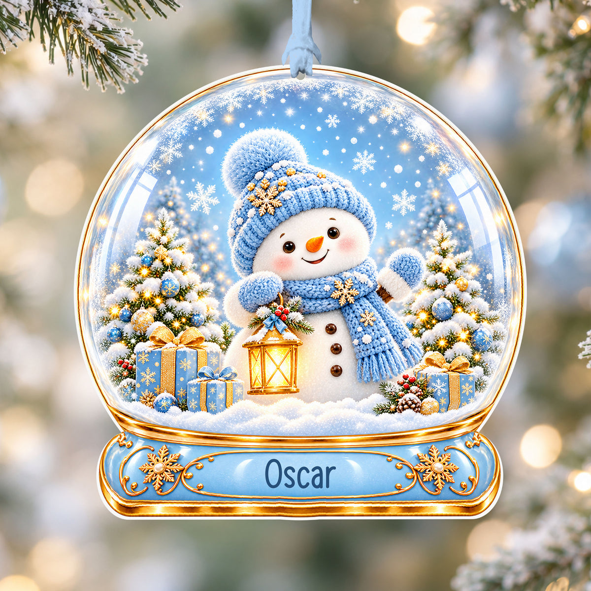Personalised blue snowman acrylic snow globe Christmas bauble with custom name, hanging on a Christmas tree with baby blue ribbon
