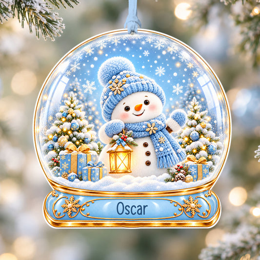 Personalised blue snowman acrylic snow globe Christmas bauble with custom name, hanging on a Christmas tree with baby blue ribbon