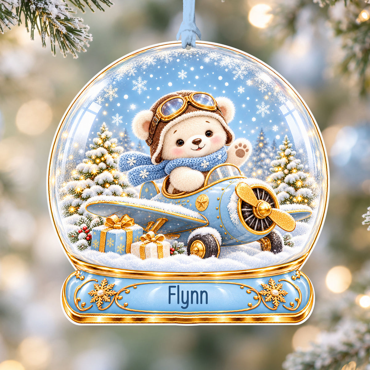 Personalised blue teddy aeroplane acrylic snow globe Christmas bauble with custom name, hanging on a Christmas tree with baby blue ribbon