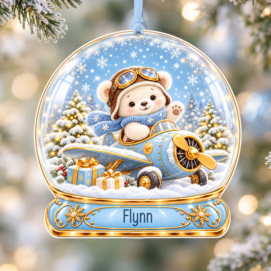 Personalised blue teddy aeroplane acrylic snow globe Christmas bauble with custom name, hanging on a Christmas tree with baby blue ribbon