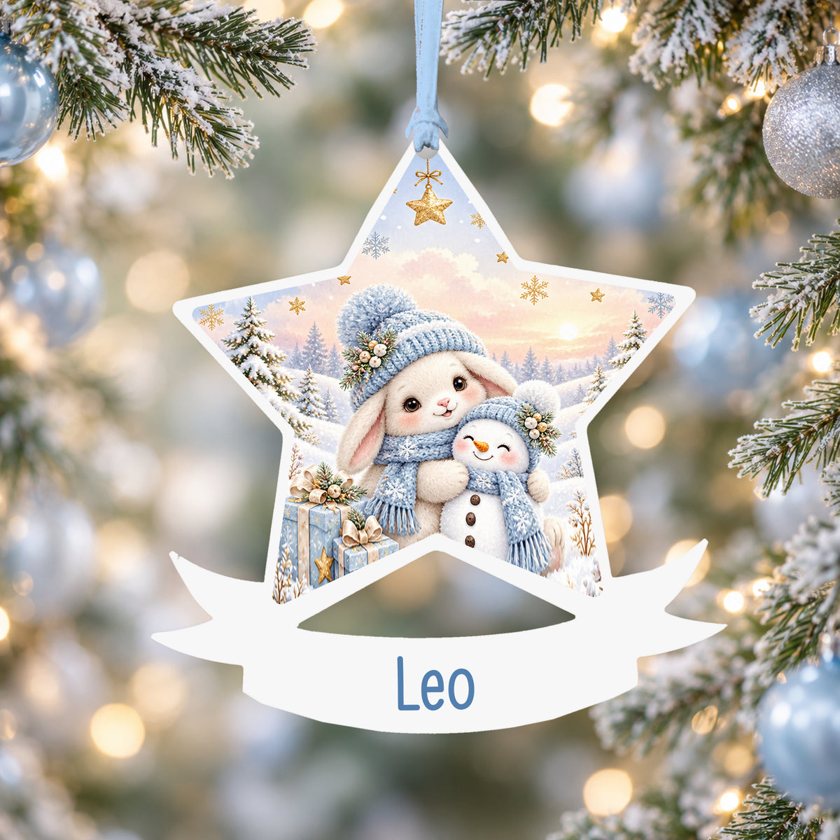 Personalised blue winter bunny acrylic star Christmas bauble with custom name, hanging on a Christmas tree with baby blue ribbon