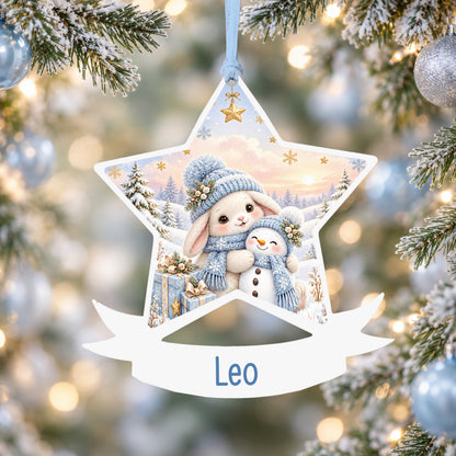 Personalised blue winter bunny acrylic star Christmas bauble with custom name, hanging on a Christmas tree with baby blue ribbon