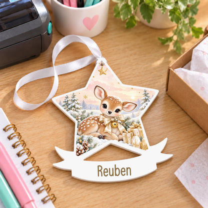Personalised champagne fawn white acrylic star bauble with name, 10cm Christmas decoration with ribbon, shown on a desk